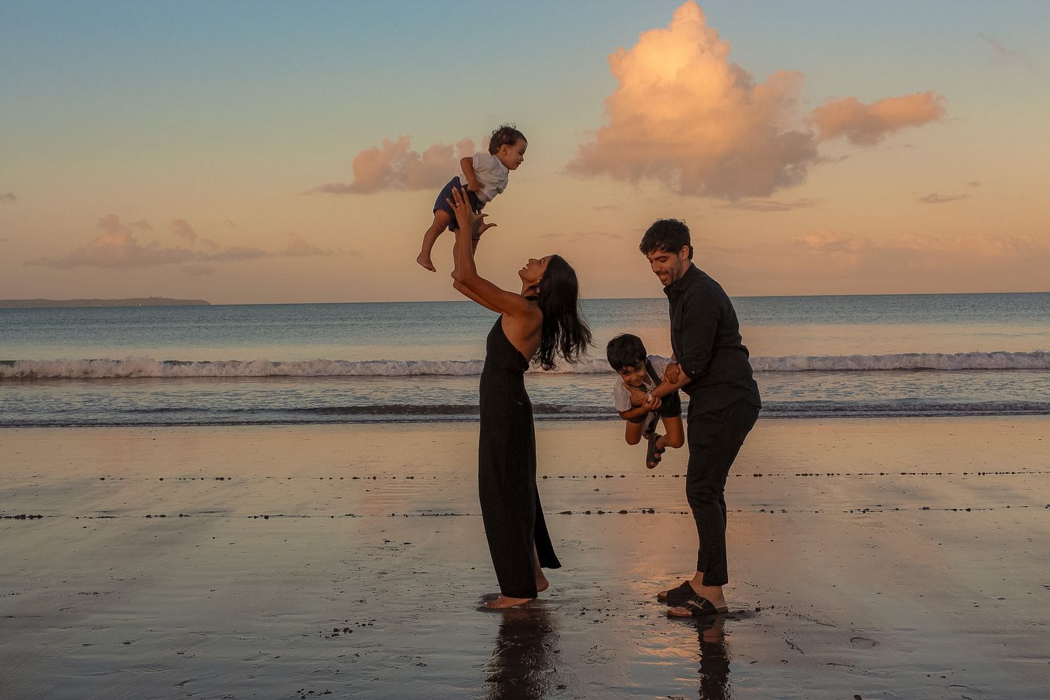Winter Golden hour family photo with both parents playing with their children.