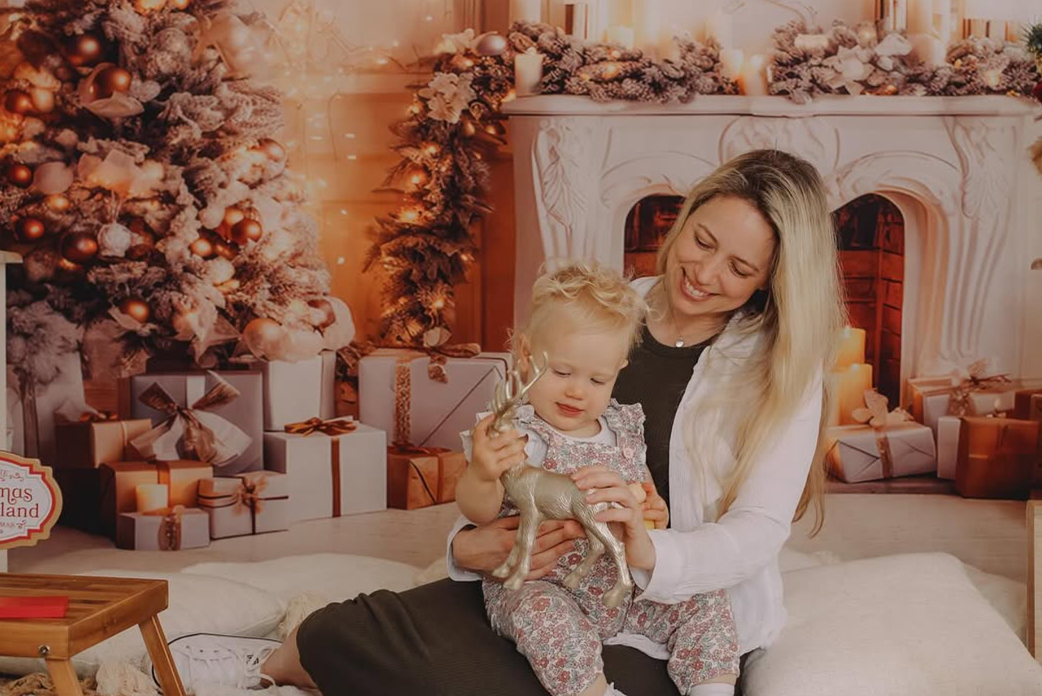 Siblings wearing matching neutral pajamas for a modern Christmas photo shoot.