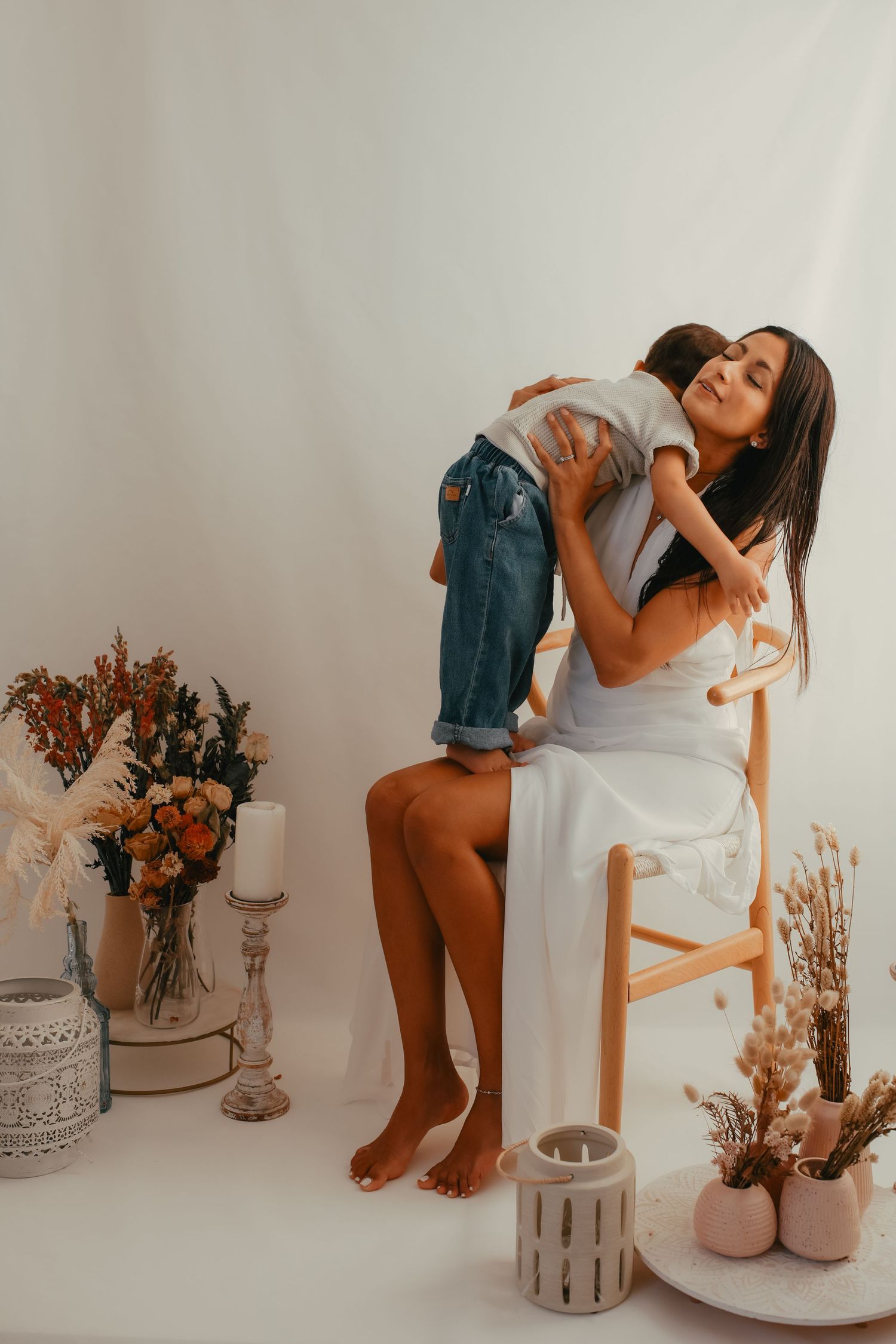 Boho maternity and motherhood session with a cream lace dress and natural outdoor lighting.