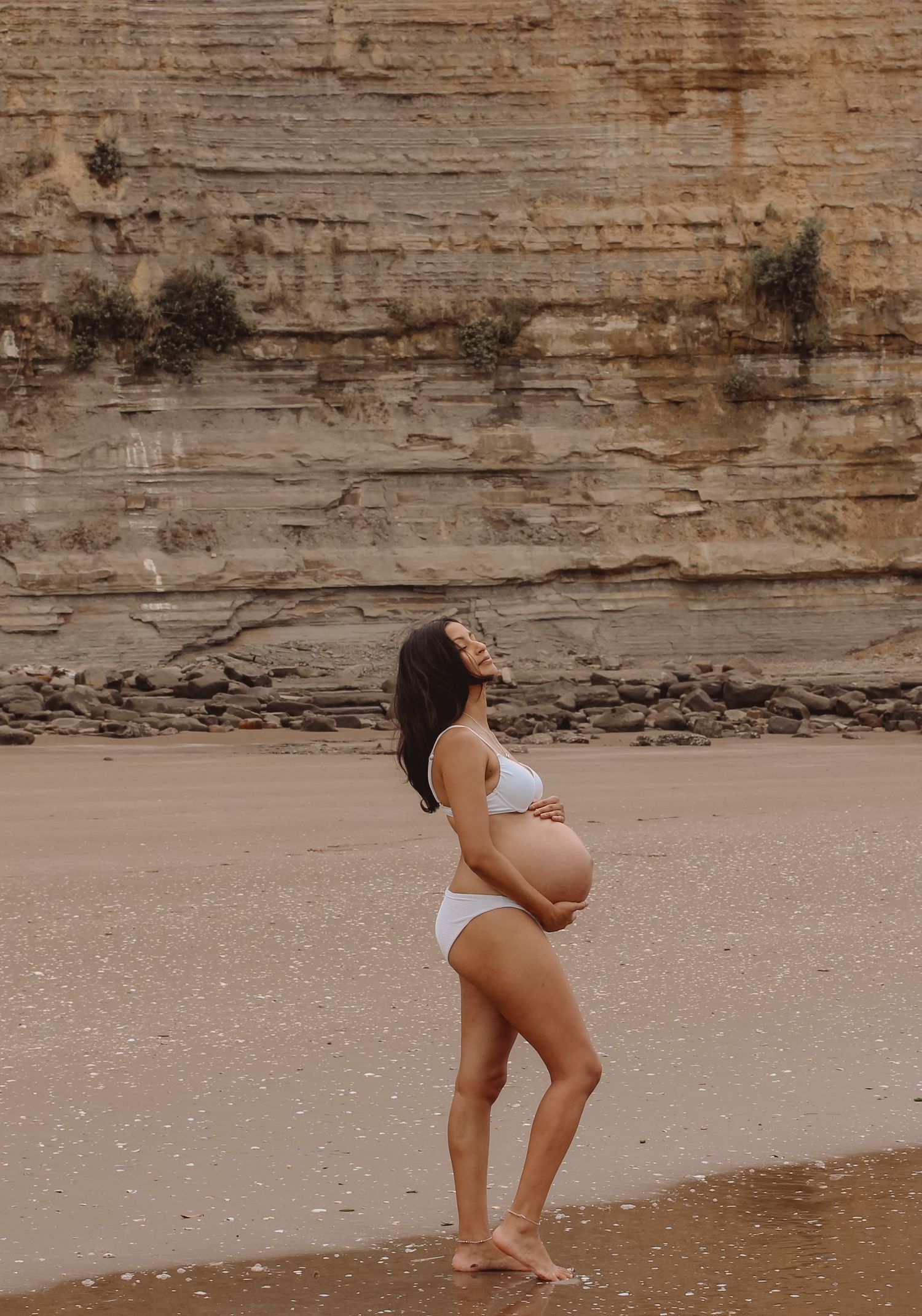 Long Bay Beach Maternity photoshoot. Soft warm golden light tones.