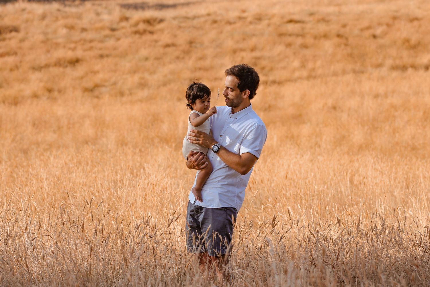 Dad and son playing, photo captures moments of interaction and play.