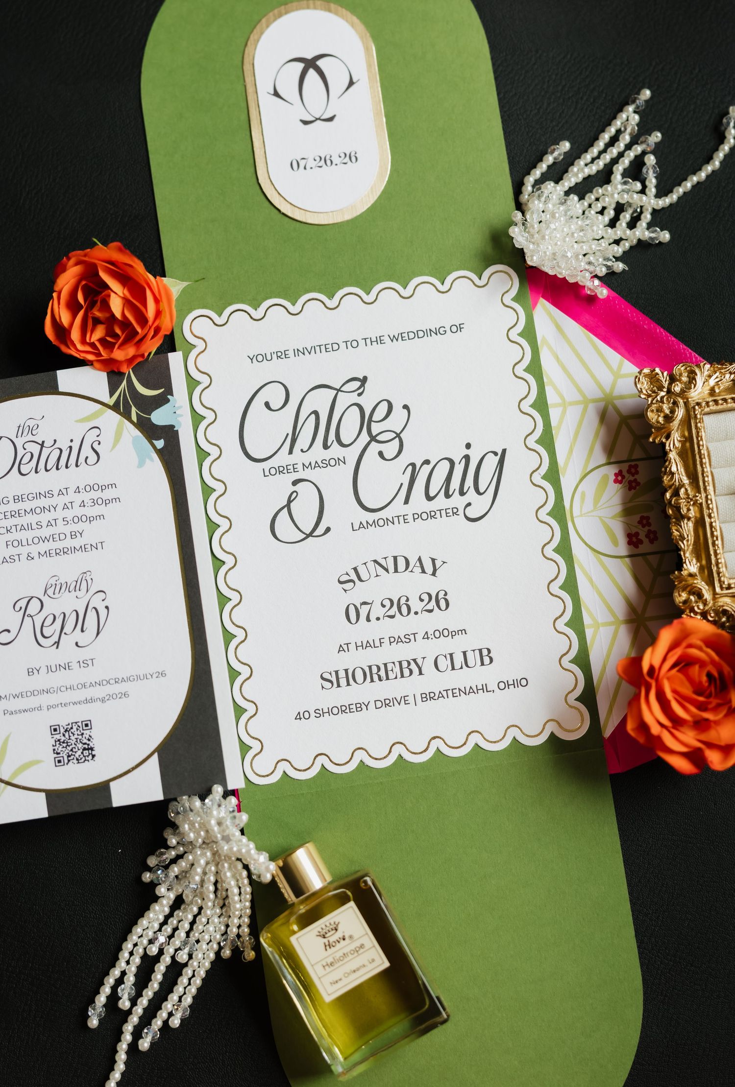 Elegant wedding invitation suite for Chloe and Craig on green backdrop with orange roses, pearl accessories, and perfume bottle.