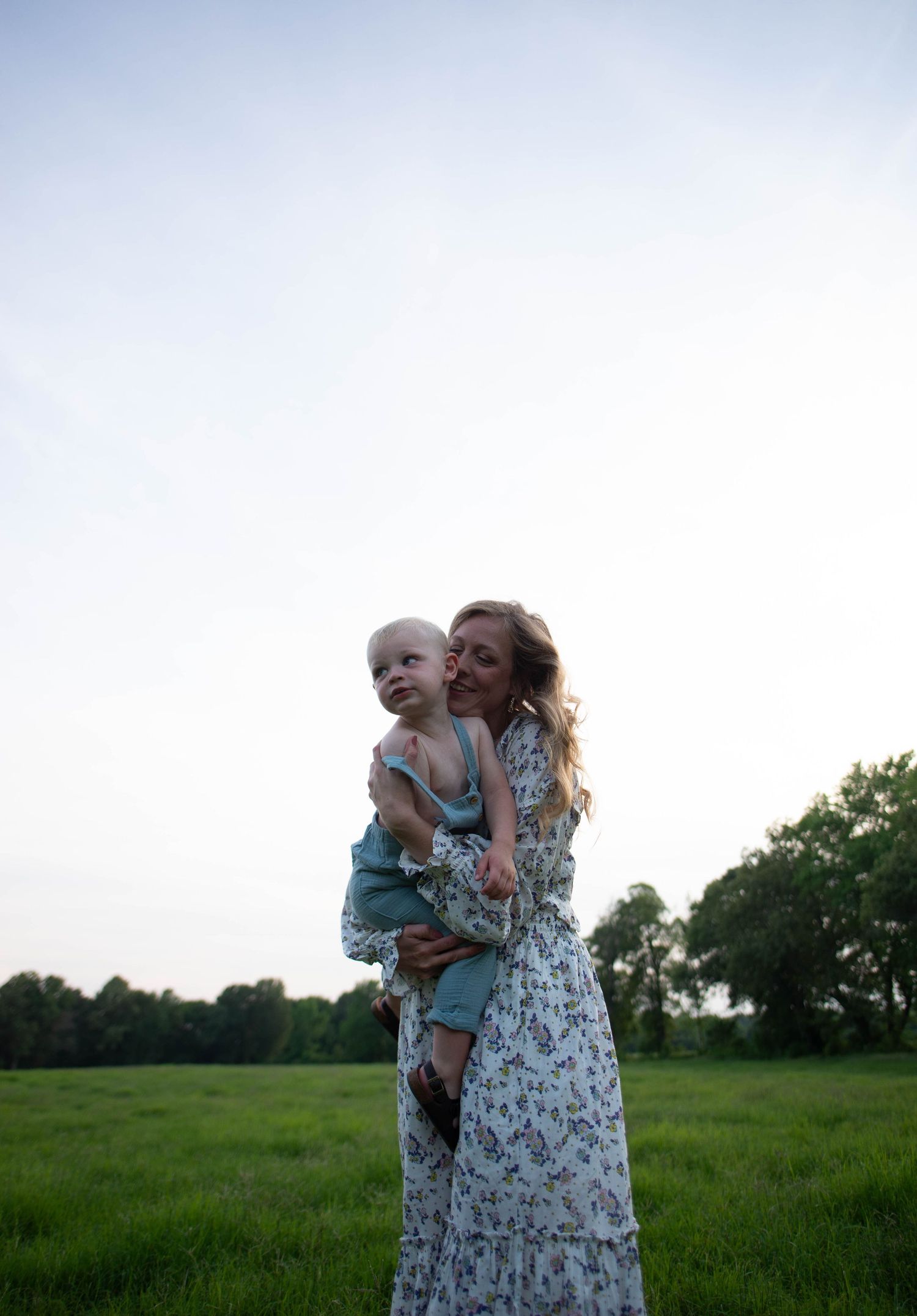 Joyful moment captured in a green meadow during sunset.
