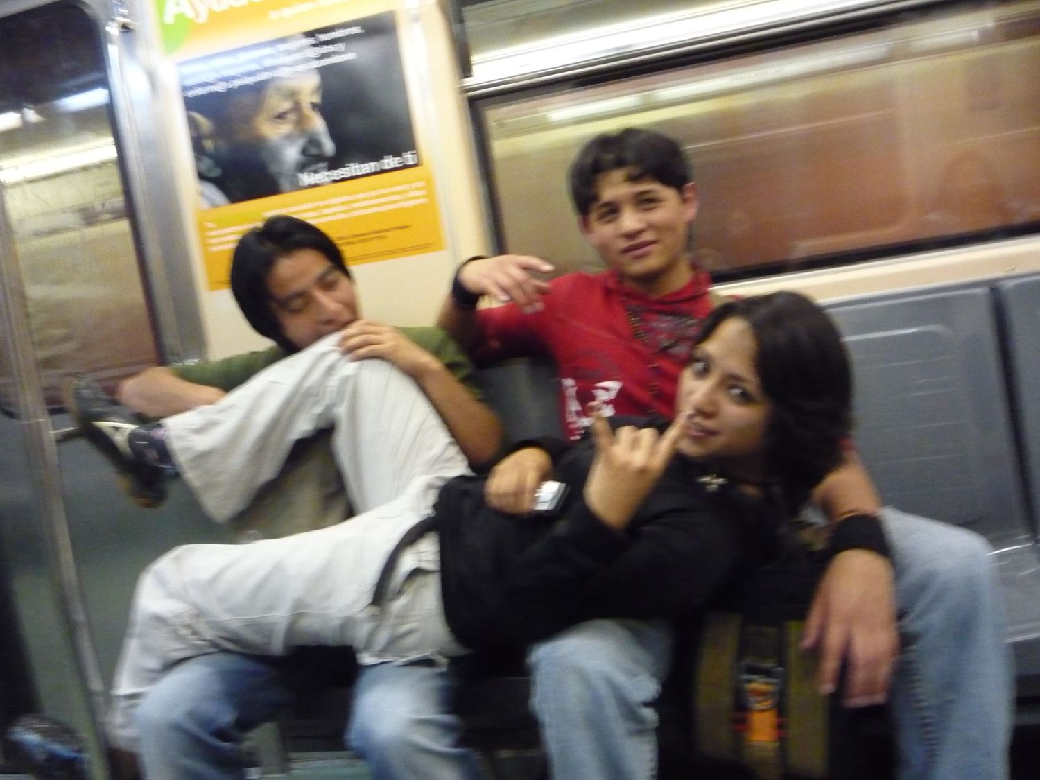 Group of friends relaxing and laughing together on a subway train.