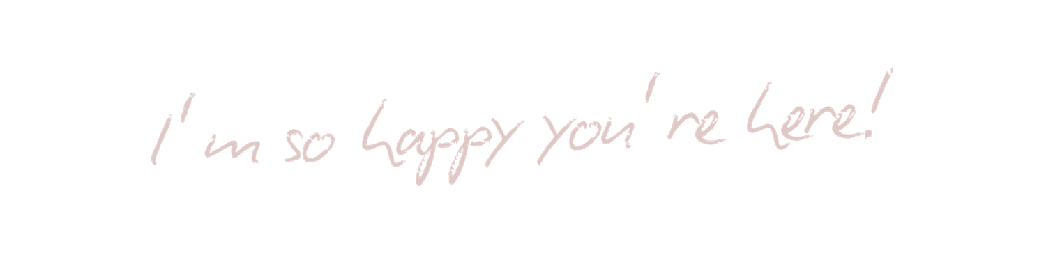A handwritten note on white paper reads 'I'm so happy you're here!' in blue ink.