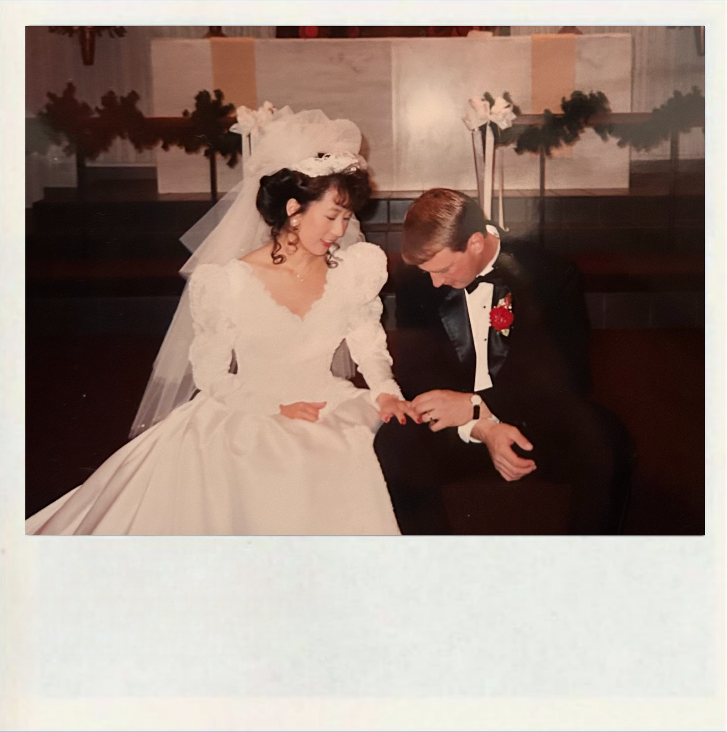 A romantic wedding couple shares an intimate dance moment during their reception celebration.