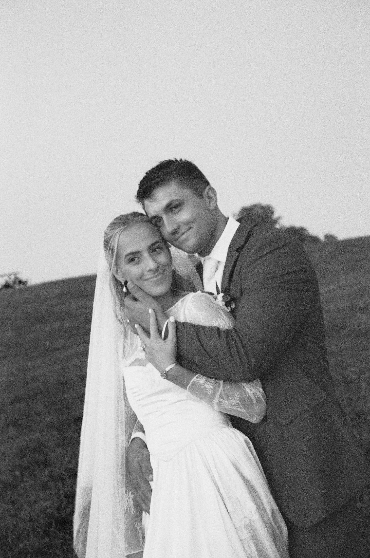 A romantic black and white wedding photo series showing a couple embracing in three similar poses outdoors.