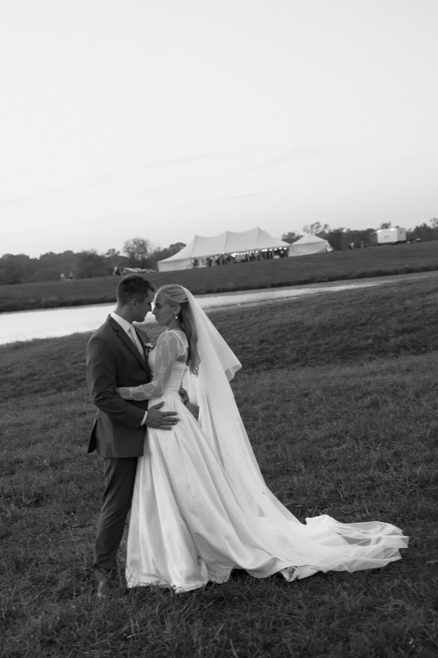 A romantic black and white wedding photo sequence showing a couple embracing in a scenic outdoor field.