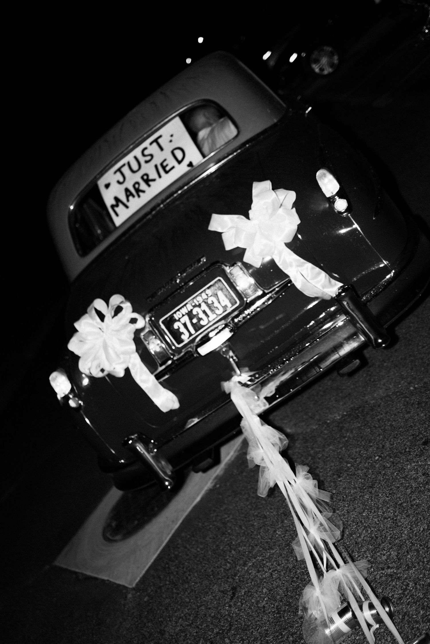 Black and white photos show a car parked at night with white decorations tied to it, suggesting a wedding celebration.