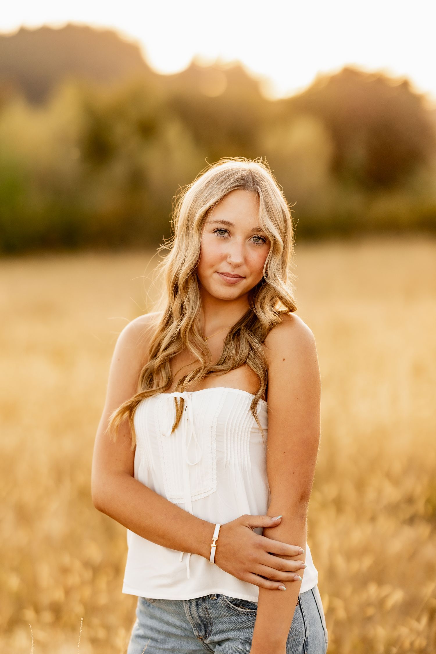 A series of golden hour portraits taken in a wheat field at sunset with warm lighting and soft bokeh effects.