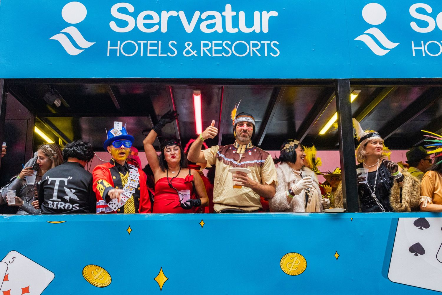 Players gather around a casino gaming table with cards and chips during an exciting poker match at Servatur Hotels & Resorts.