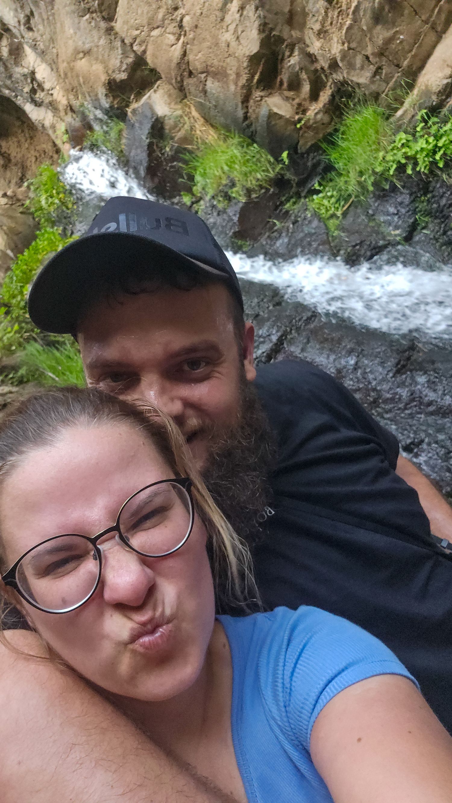 A series of selfie photos taken near a rocky waterfall showing people enjoying nature outdoors.