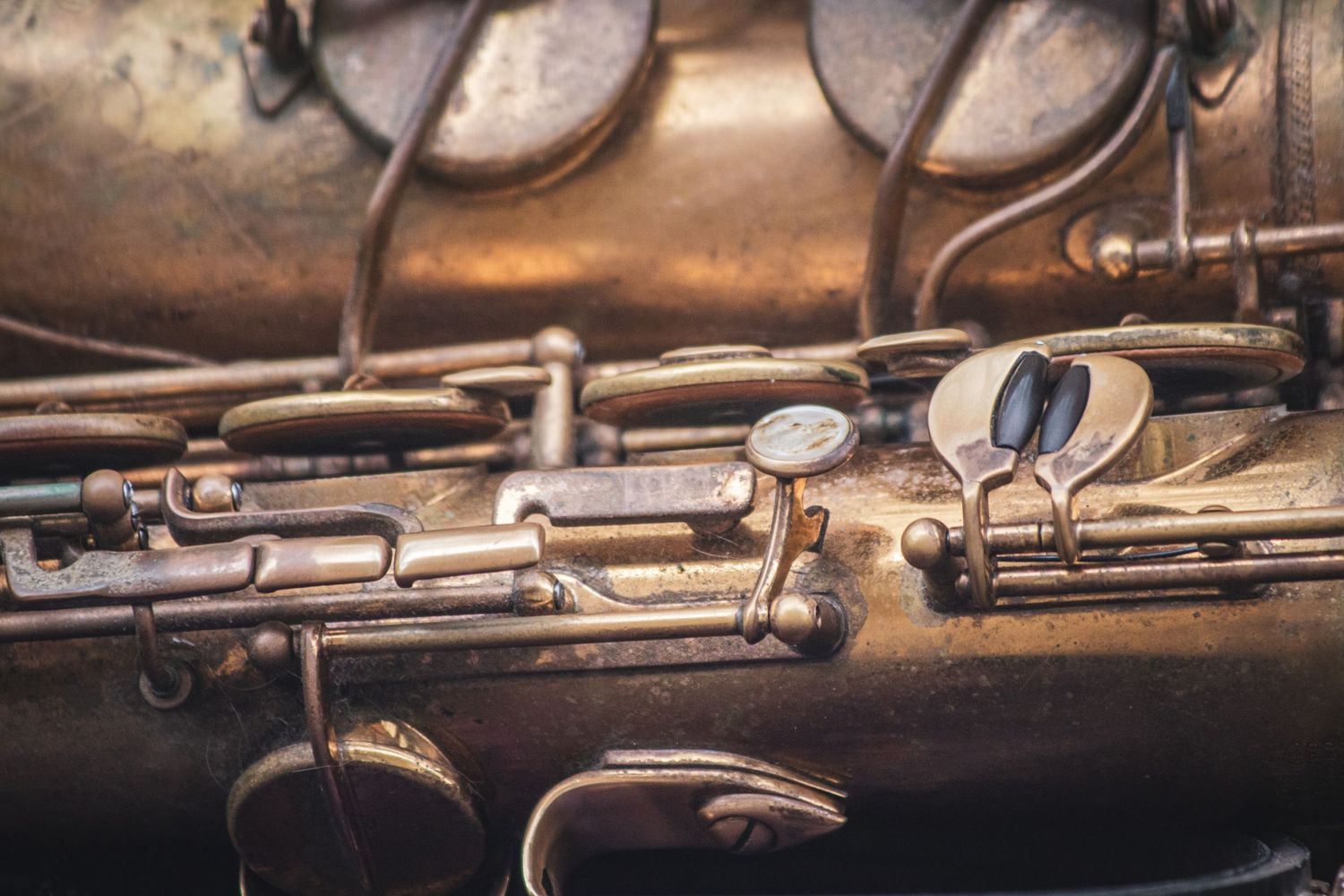 Close-up macro photography of antique musical instruments showing intricate brass details and mechanisms.