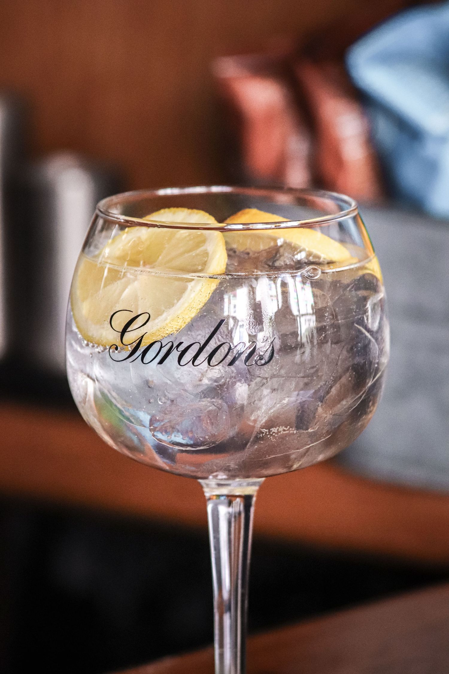Crystal champagne coupe glass with Gordon's branding shown from different angles in a sequence of photos.