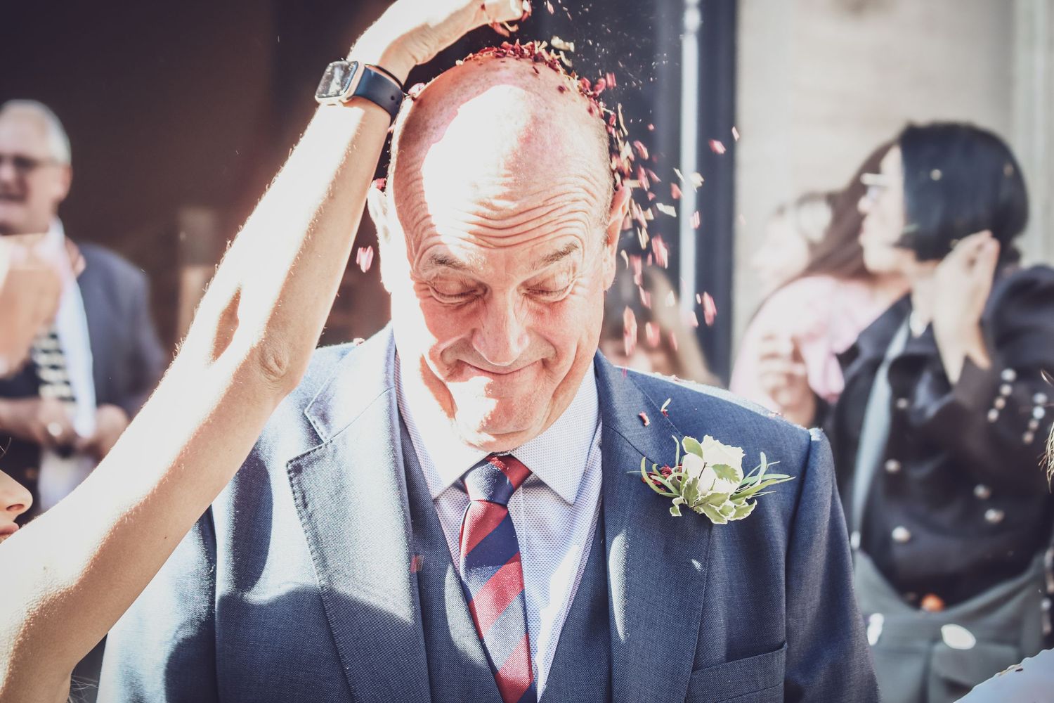Wedding guests celebrate with sparklers held high during an outdoor evening reception celebration.