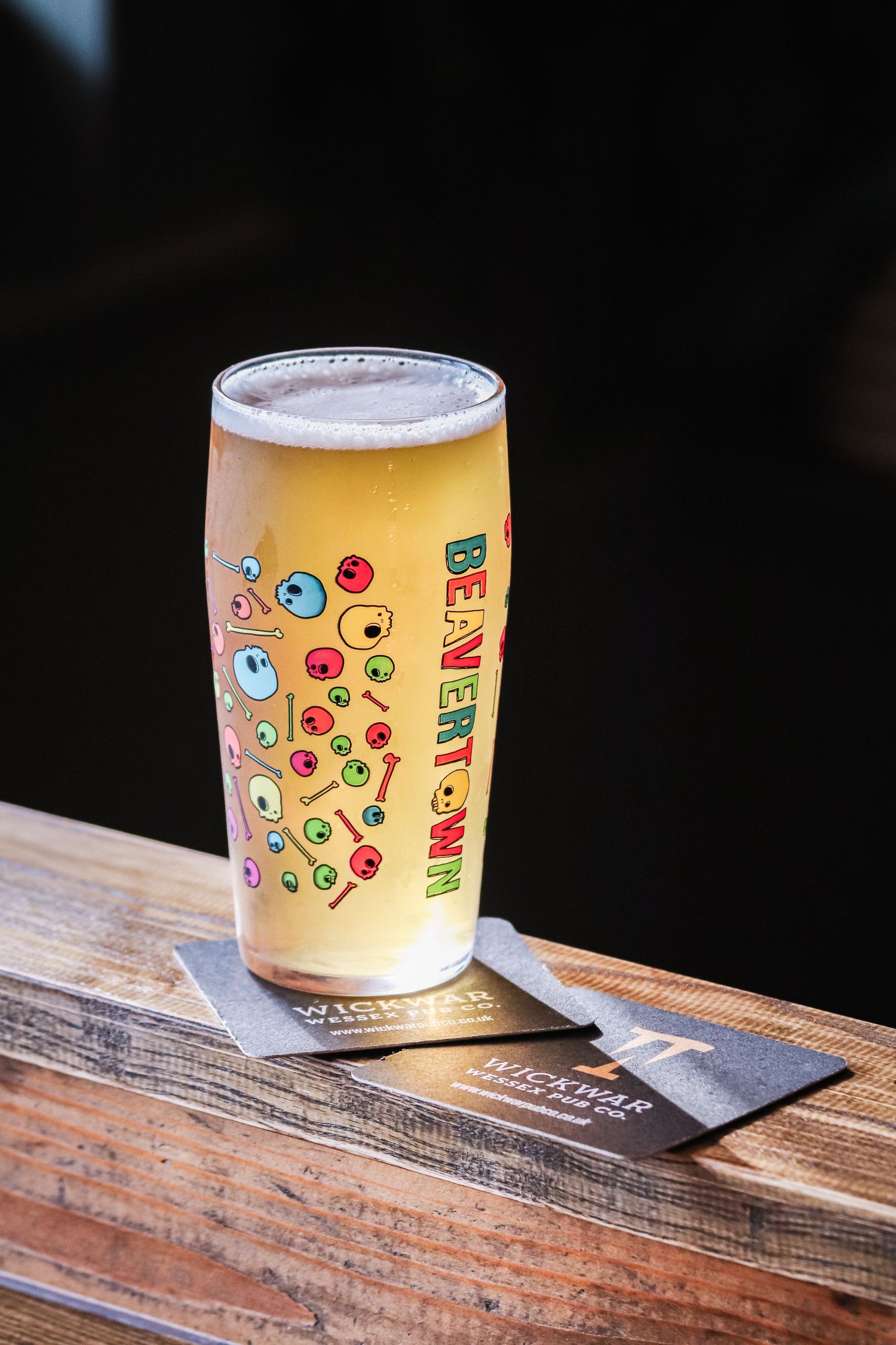 A series of four sequential photos showing a yellow bubble tea cup with cartoon eyes and emoji designs on a wooden surface.