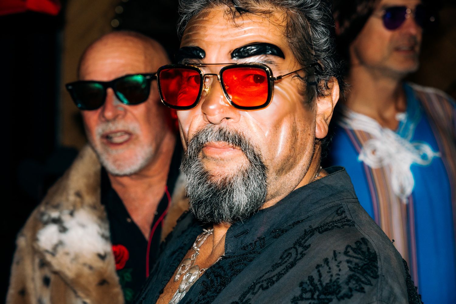 A series of black and white portrait photos showing someone with sunglasses and a beard in different poses.