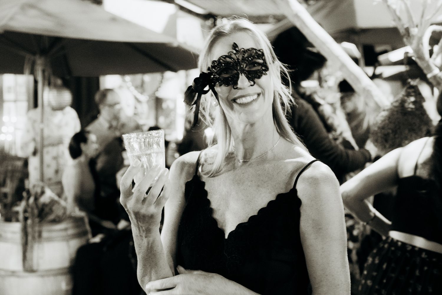 A collection of black and white candid wedding photos showing joyful moments and celebrations at a reception.
