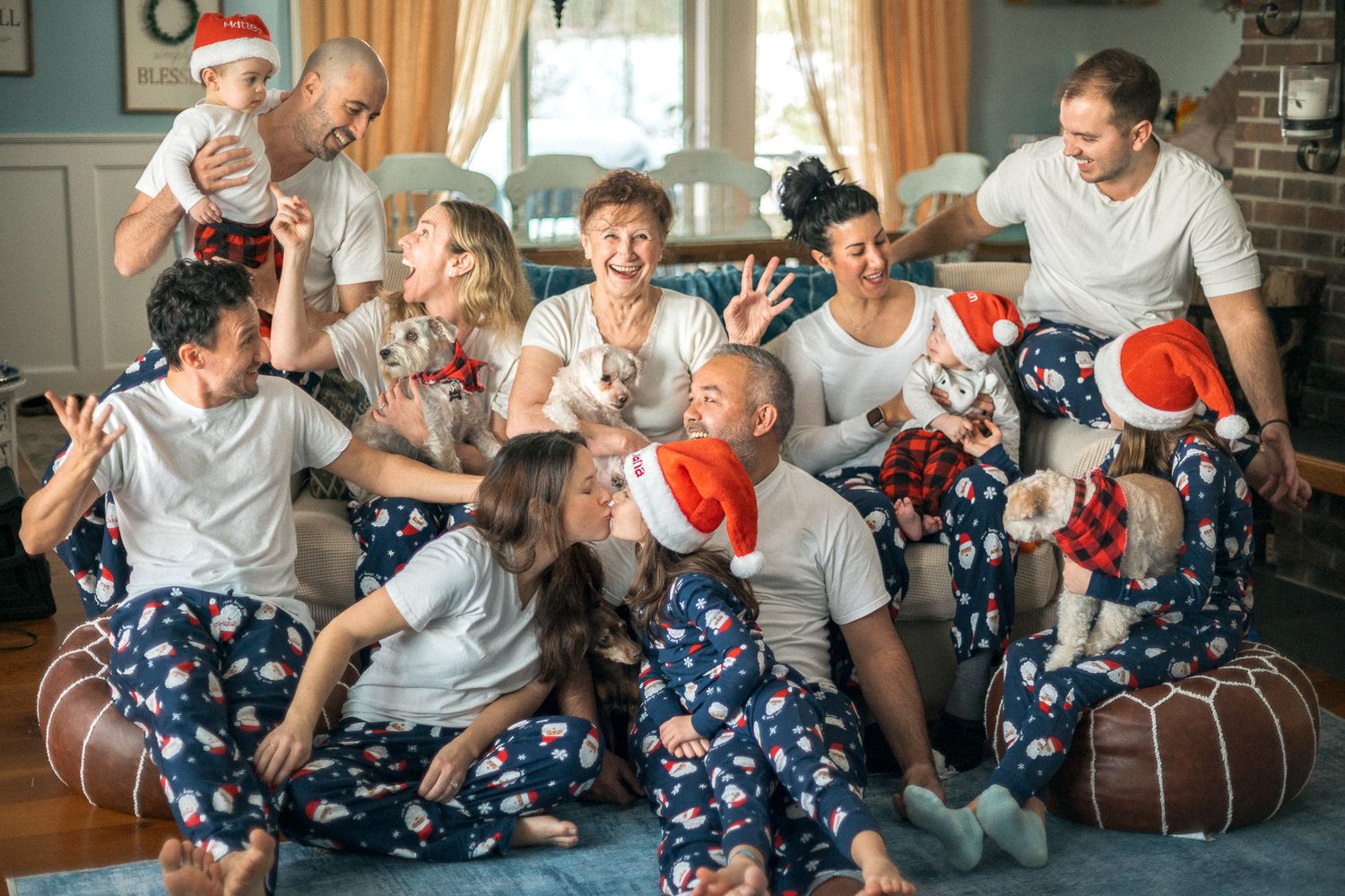 People in holiday pajamas celebrating, sharing joyful moments while exchanging gifts during Christmas. Mariano Alvarez family photographer