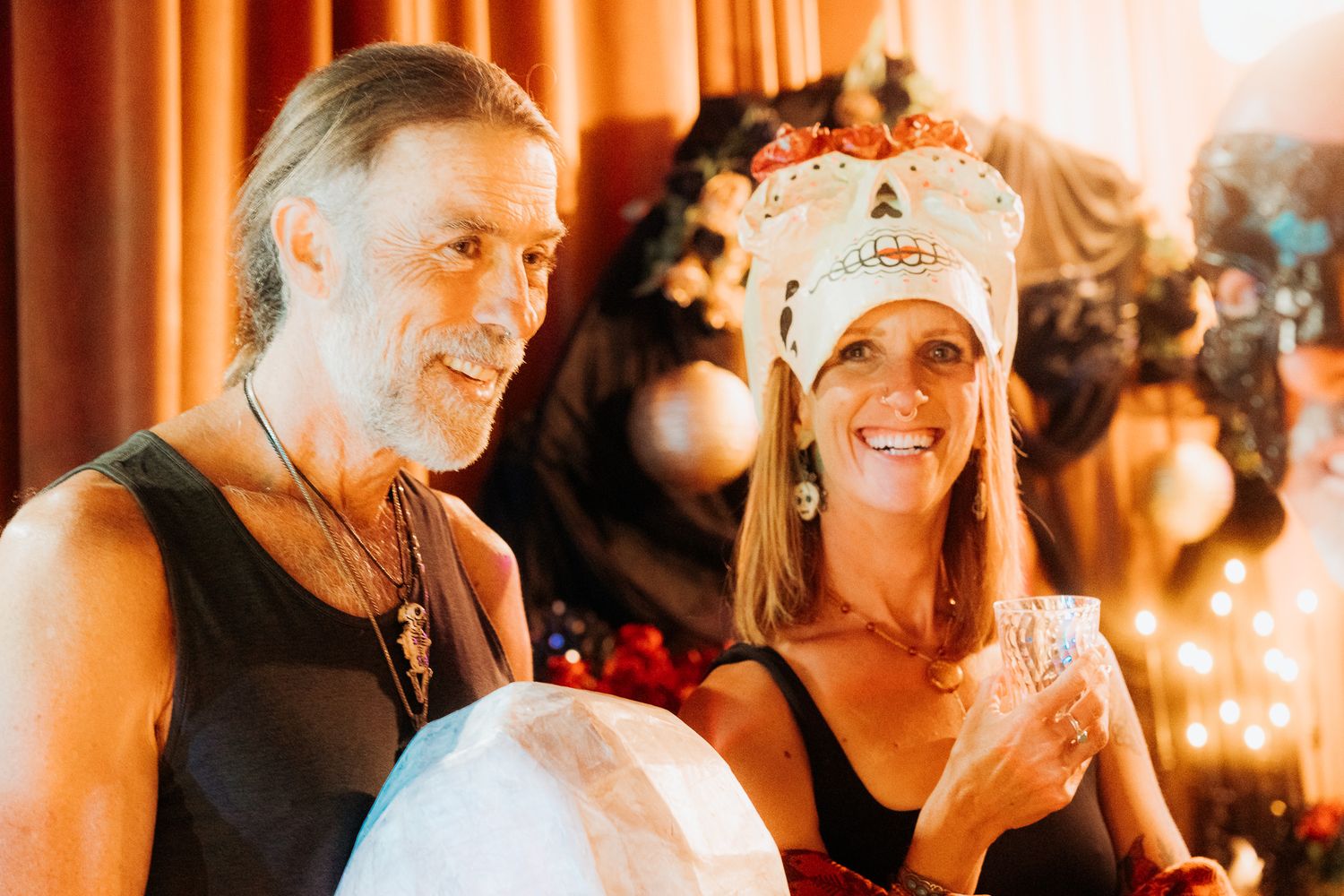 Warm-toned party scene with orange lighting and festive decorations creating an intimate atmosphere.