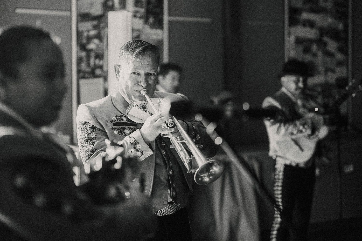 Black and white photo series showing musicians performing on stage with guitars and instruments.