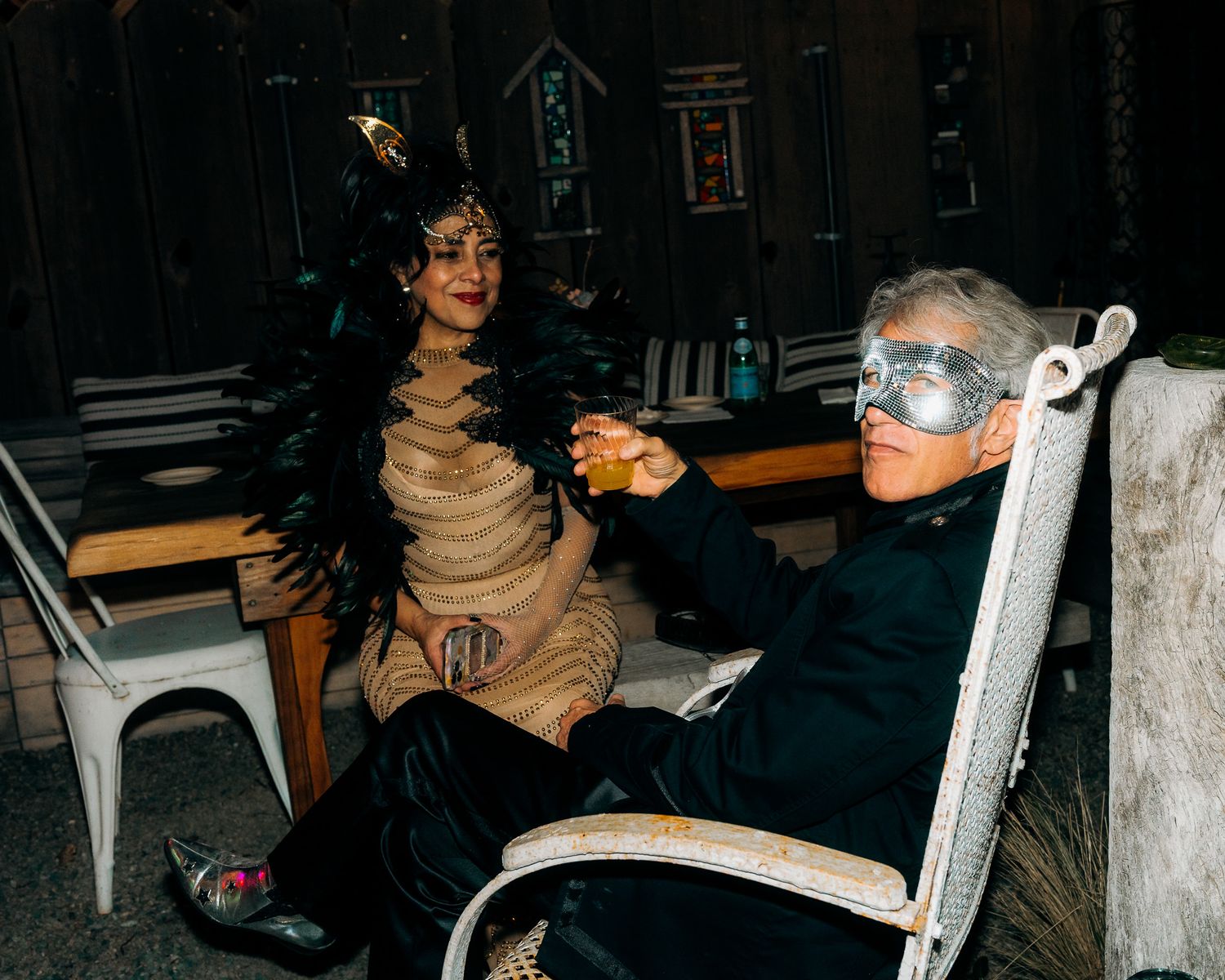 A series of dark, atmospheric nighttime photos showing a white chair and people in dim lighting.