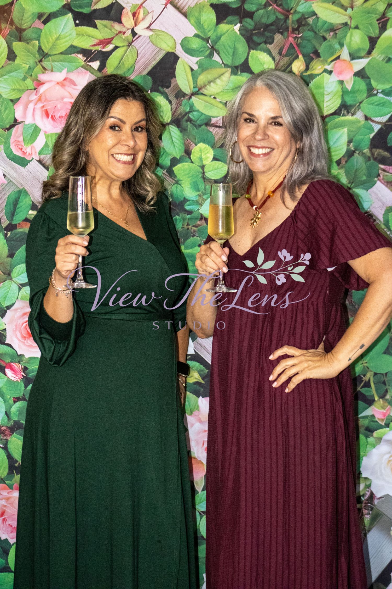 Two guests posing together during a community event photographed by View The Lens Studio.