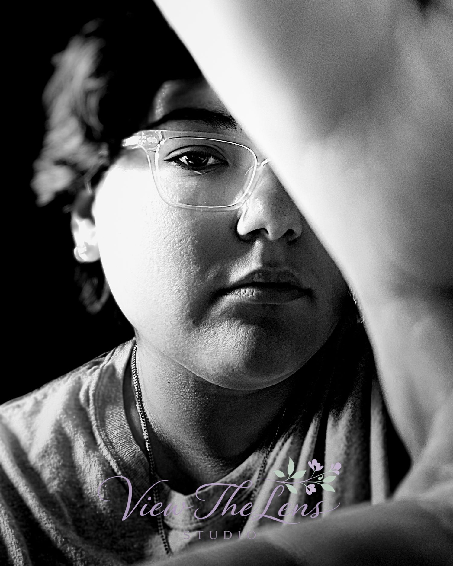 Creative black and white portrait emphasizing expression and natural light captured by View The Lens Studio.