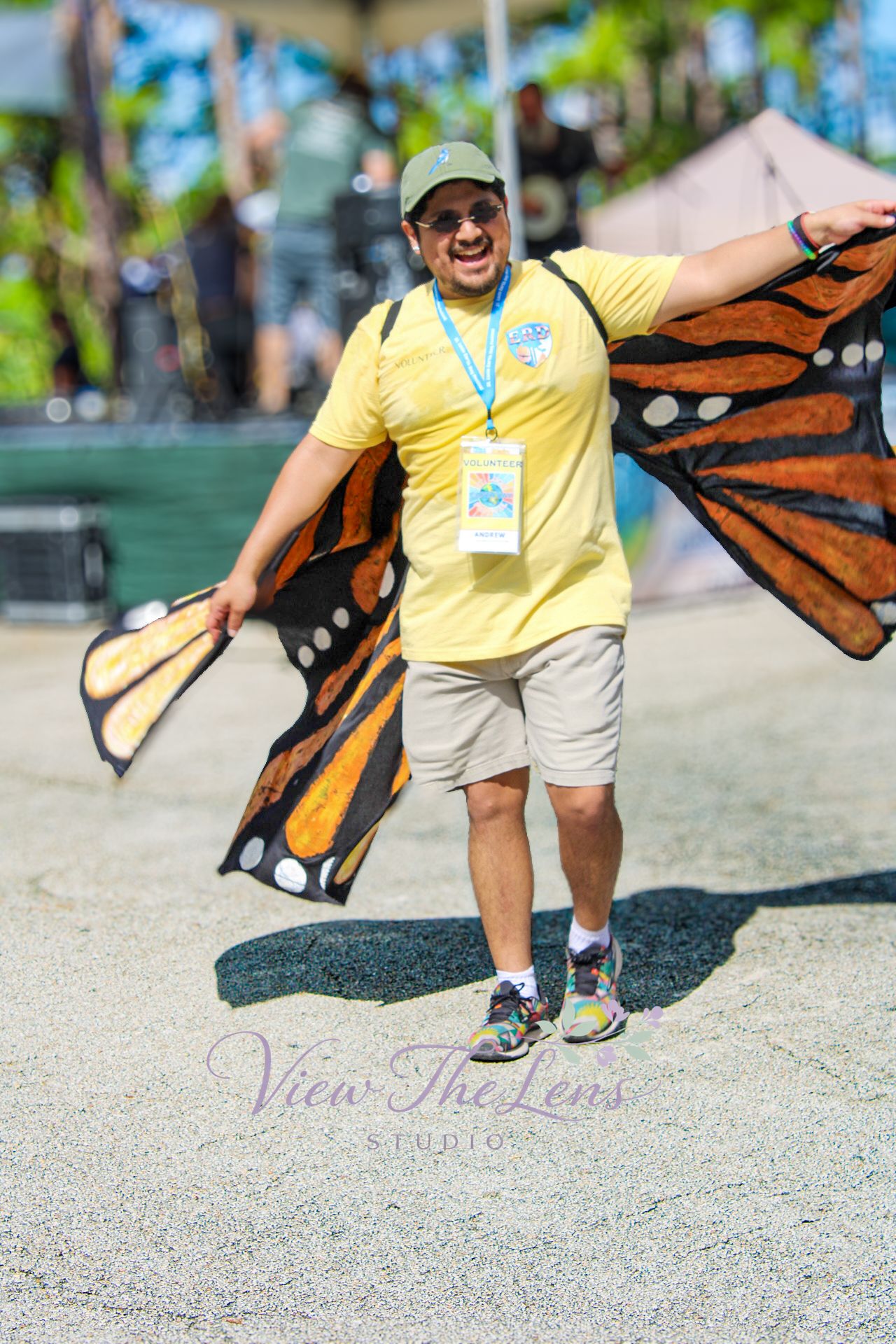 Person wearing butterfly wings during a community event photographed by View The Lens Studio.