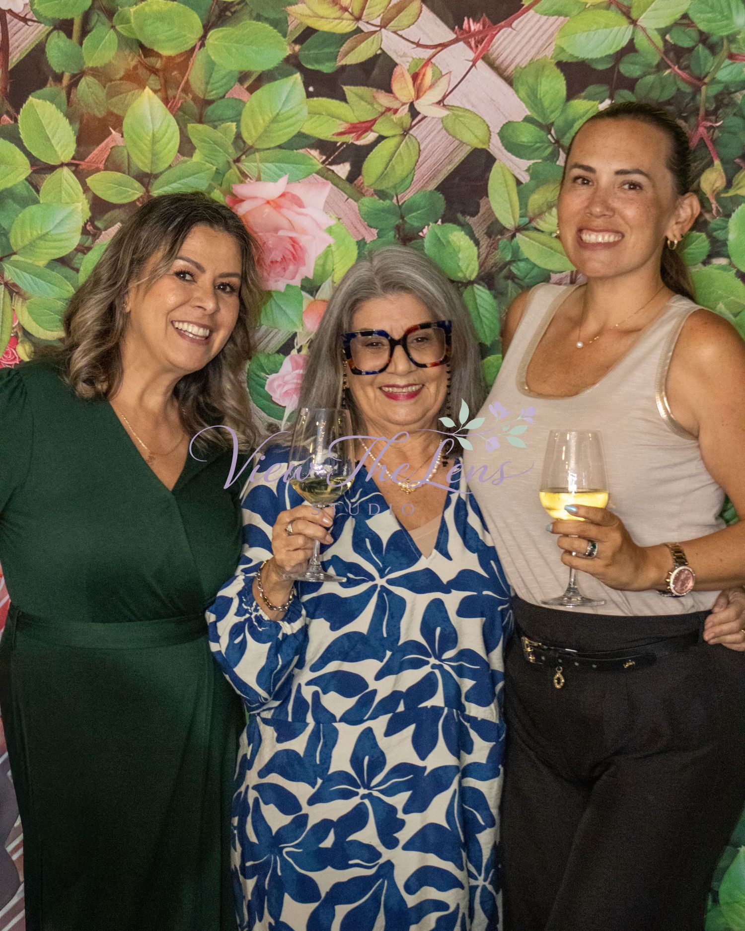 Three guests smiling together during a community event photographed by View The Lens Studio.