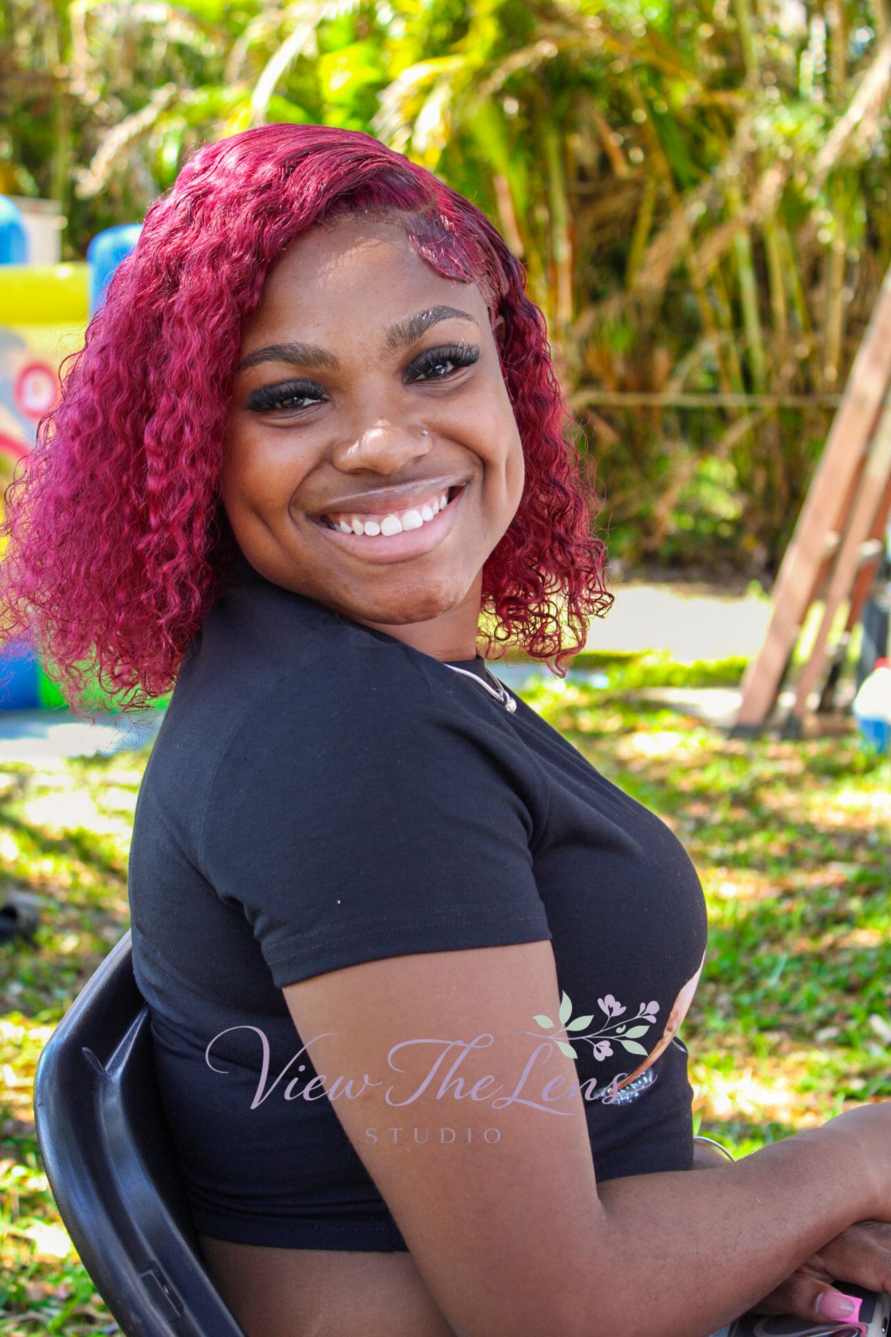 Smiling woman during an outdoor portrait session photographed by View The Lens Studio.