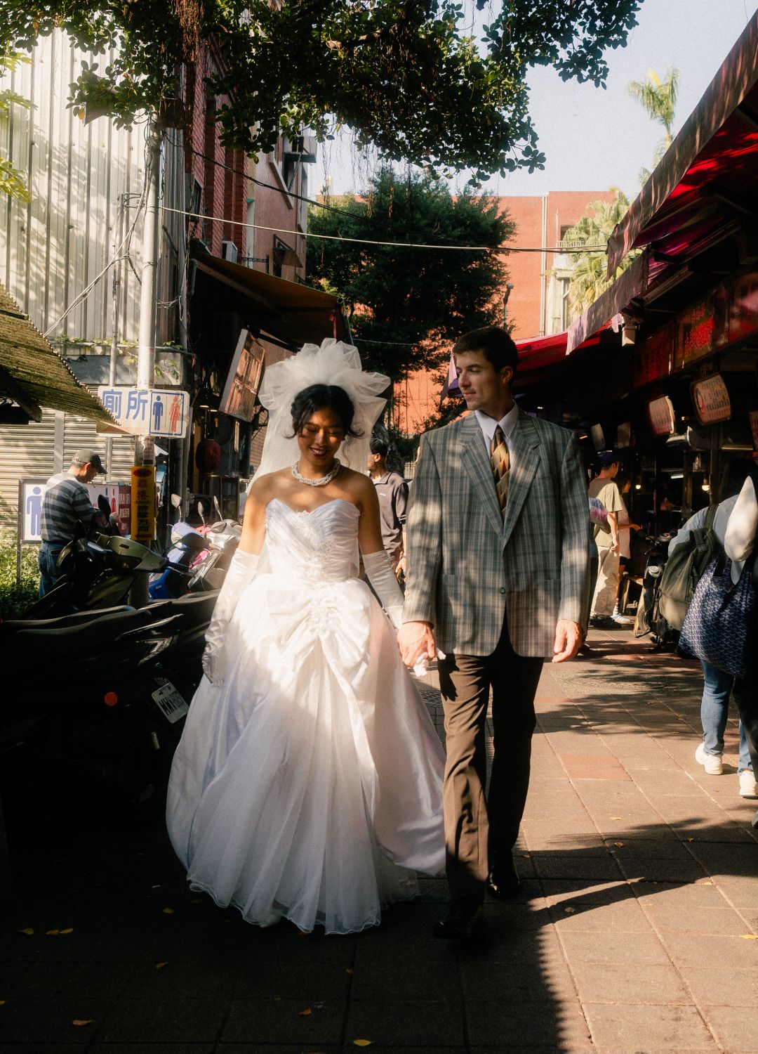 Emily and Nik walking through Dihua Street during a cinematic Taipei pre-wedding photoshoot