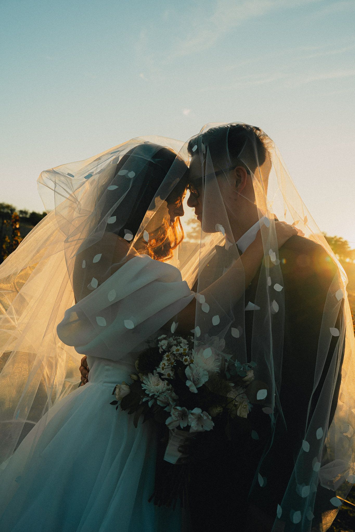 Romantic Taiwan pre-wedding portrait of a couple under a bridal veil in a vineyard