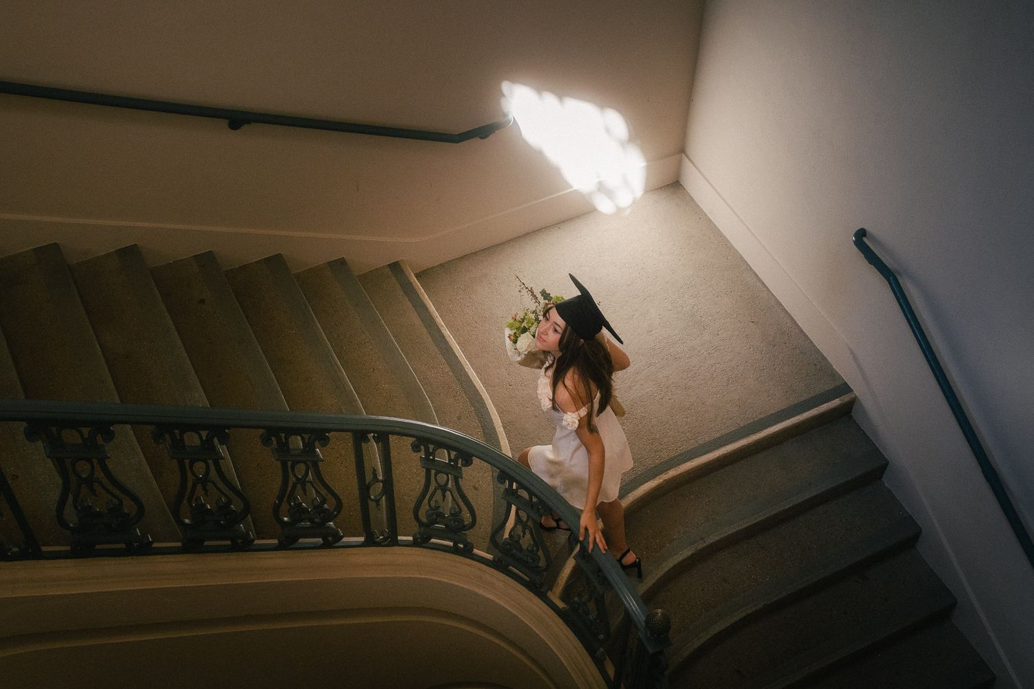 Graduate walking up a staircase during a cinematic Taipei graduates photography session
