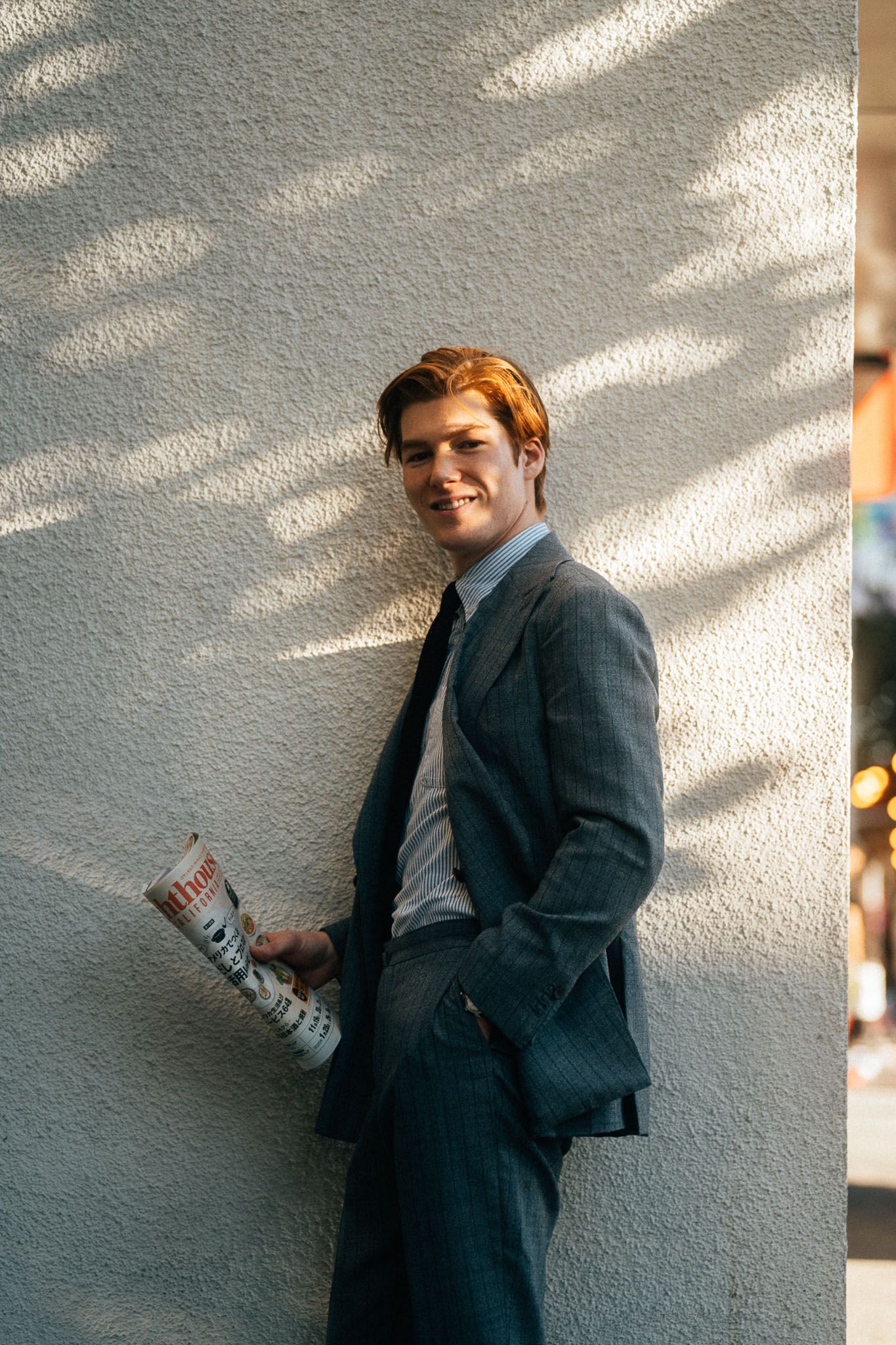 Taipei portrait photography of a man in an editorial street style by a sunlit wall