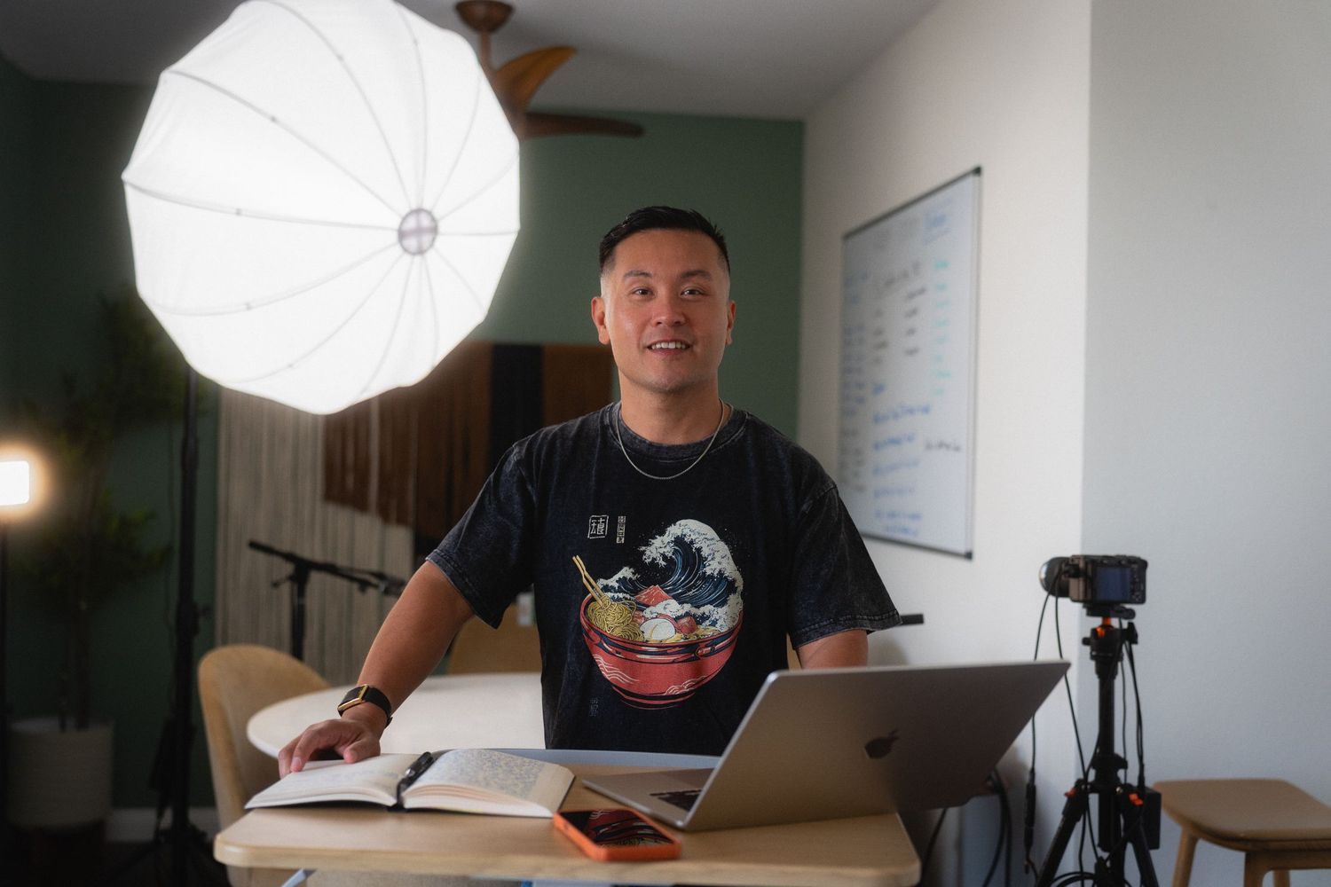 Taipei personal branding photography of a podcast creator working at a desk with camera and studio light