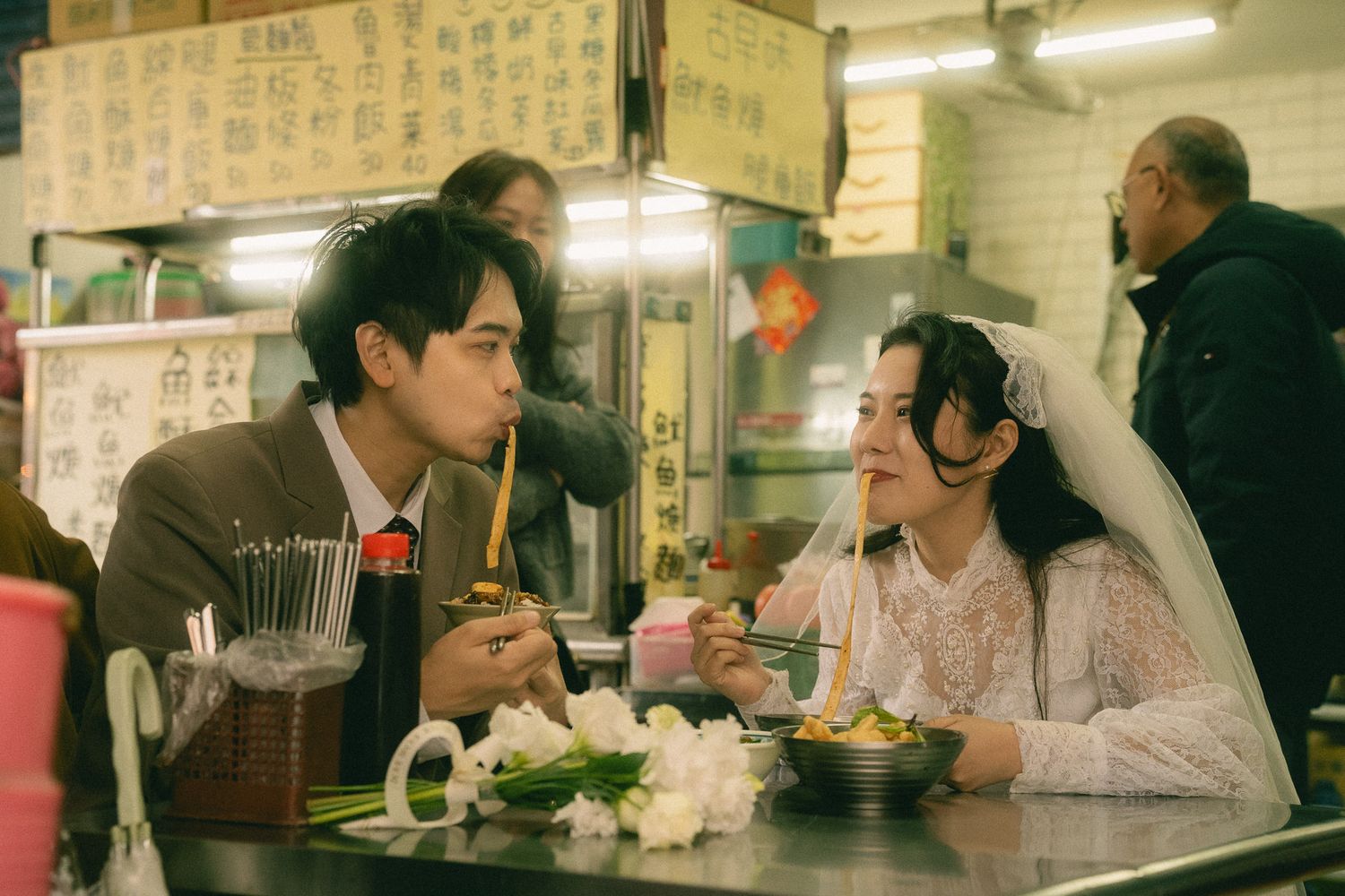 Taipei pre-wedding photography of a couple sharing noodles at a traditional Taiwanese food stall