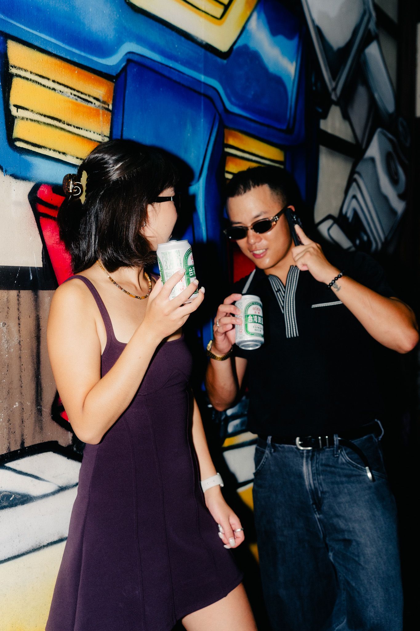 Couple with Taiwan Beer and sunglasses photographed with direct flash during a Taipei night photoshoot