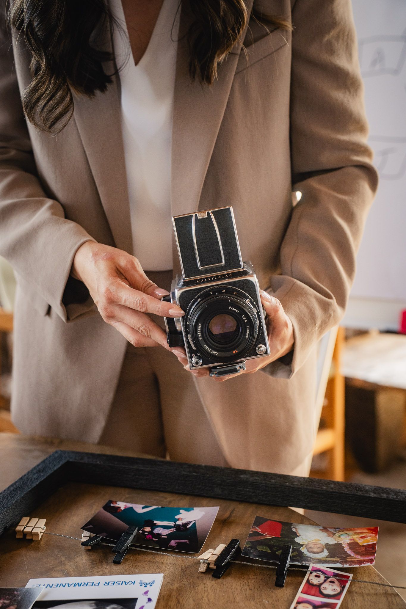 Taipei personal branding photography detail of a professional holding a camera and printed photos