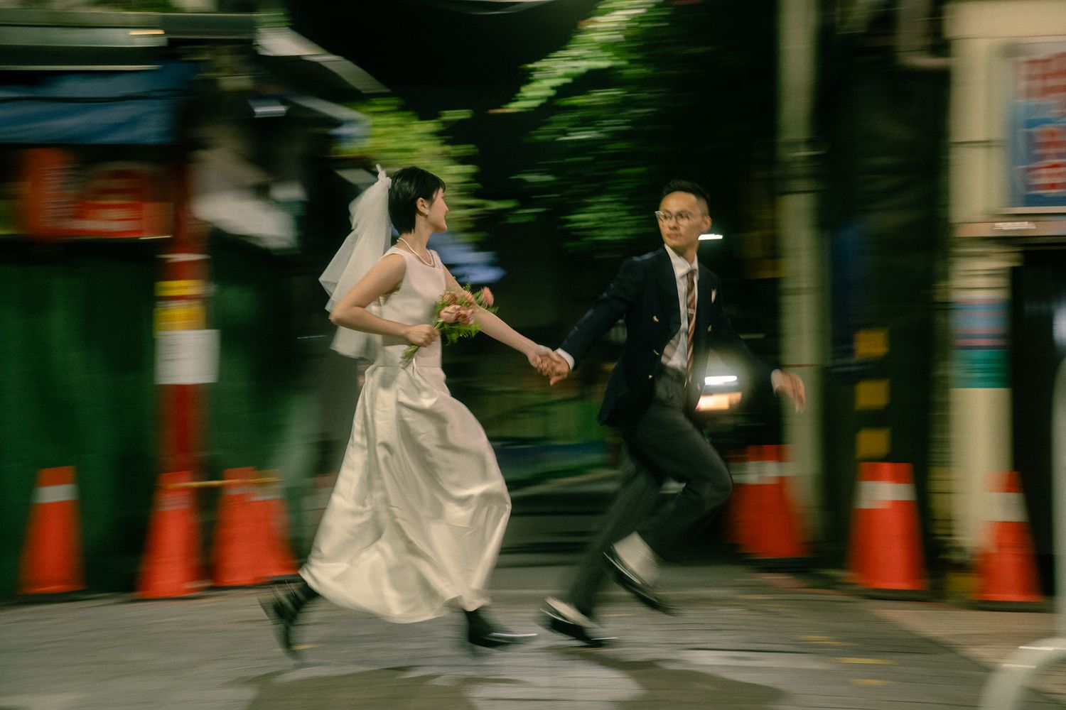 Cinematic Taipei pre-wedding photo of a bride and groom running through the city