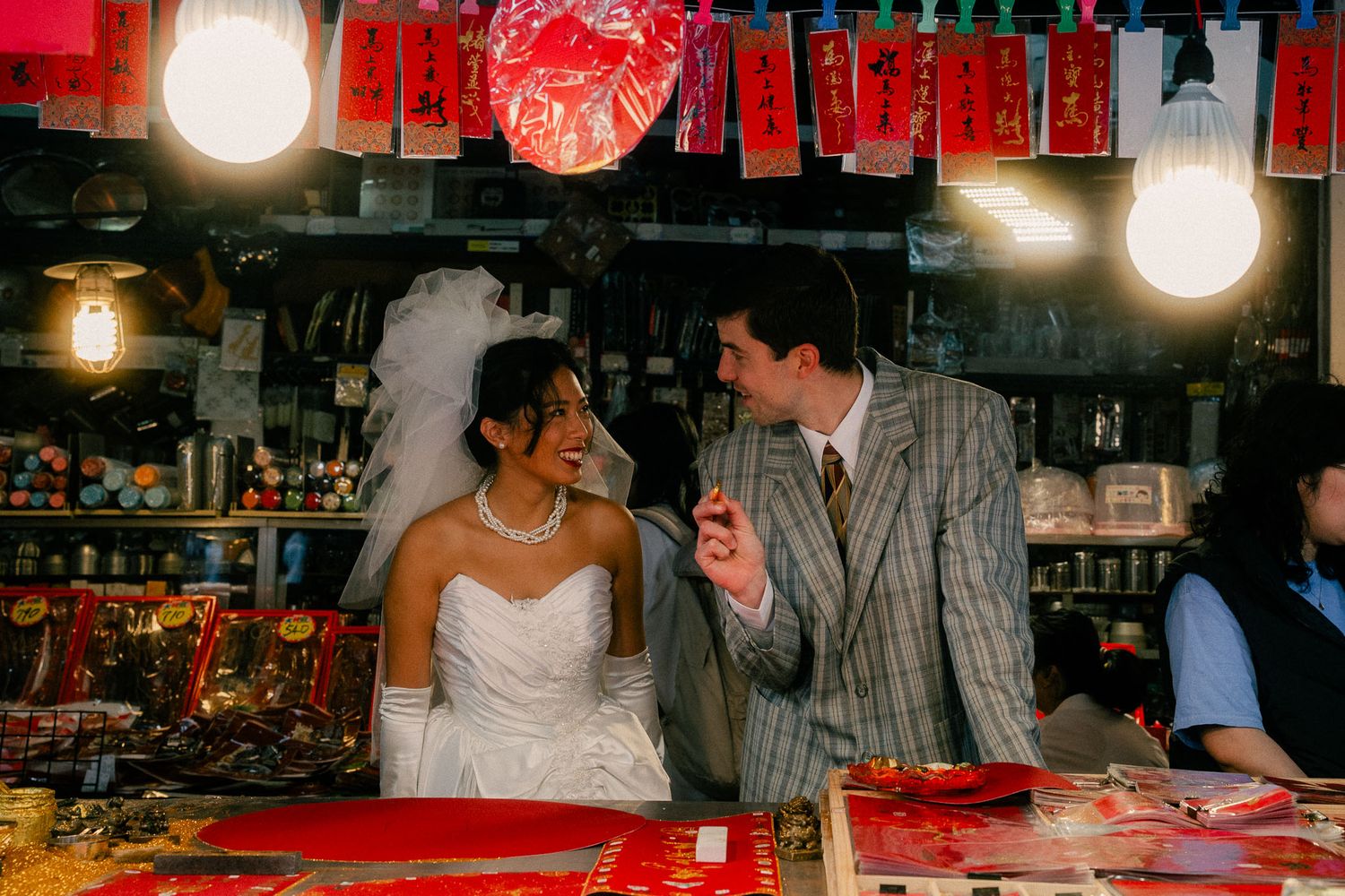 Emily and Rik laughing together inside a traditional shop during their Dihua Street pre-wedding session in Taipei