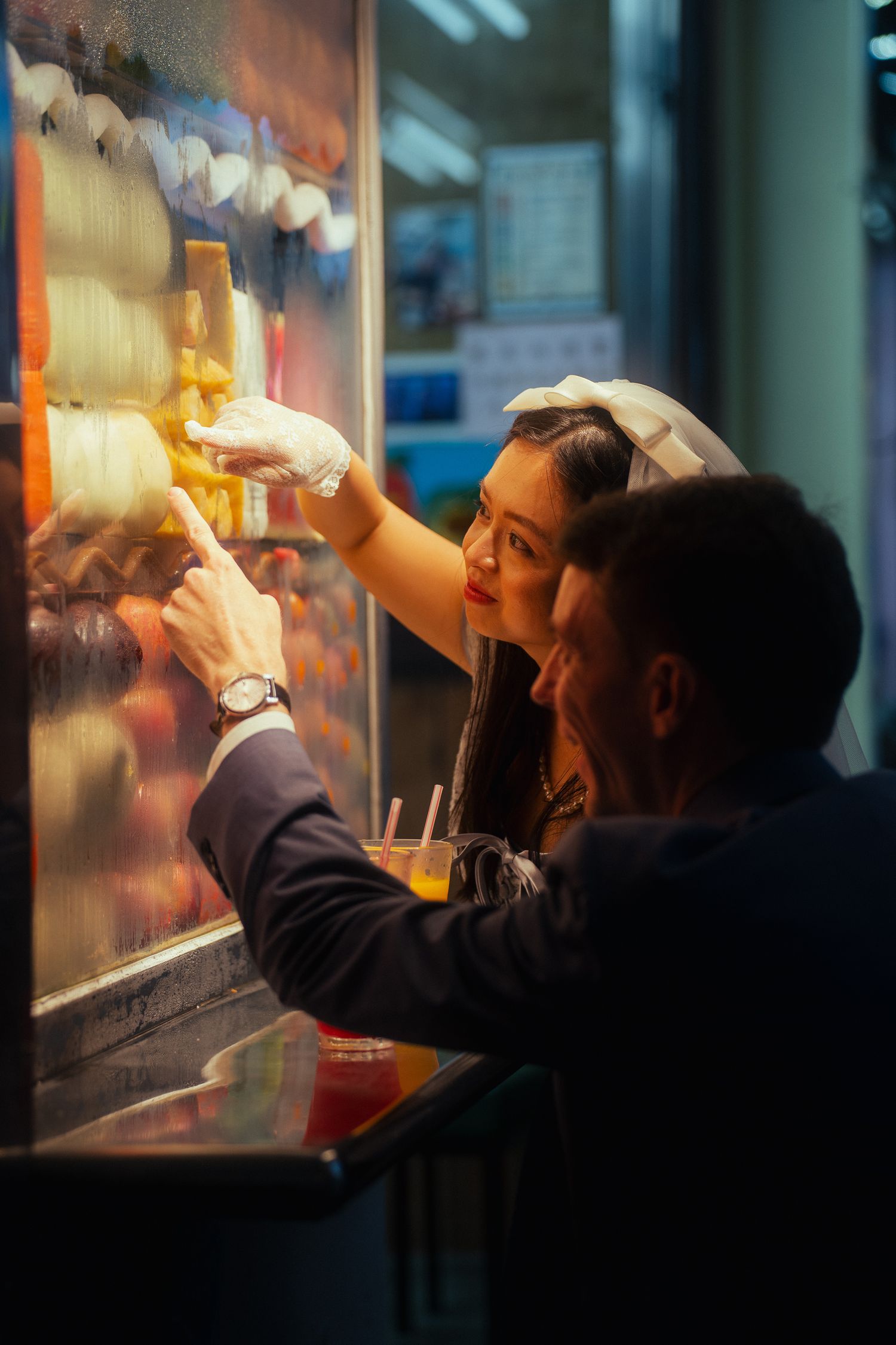Couple choosing fruit together at Huaxi Street Night Market during a documentary-style Taipei pre-wedding photoshoot.