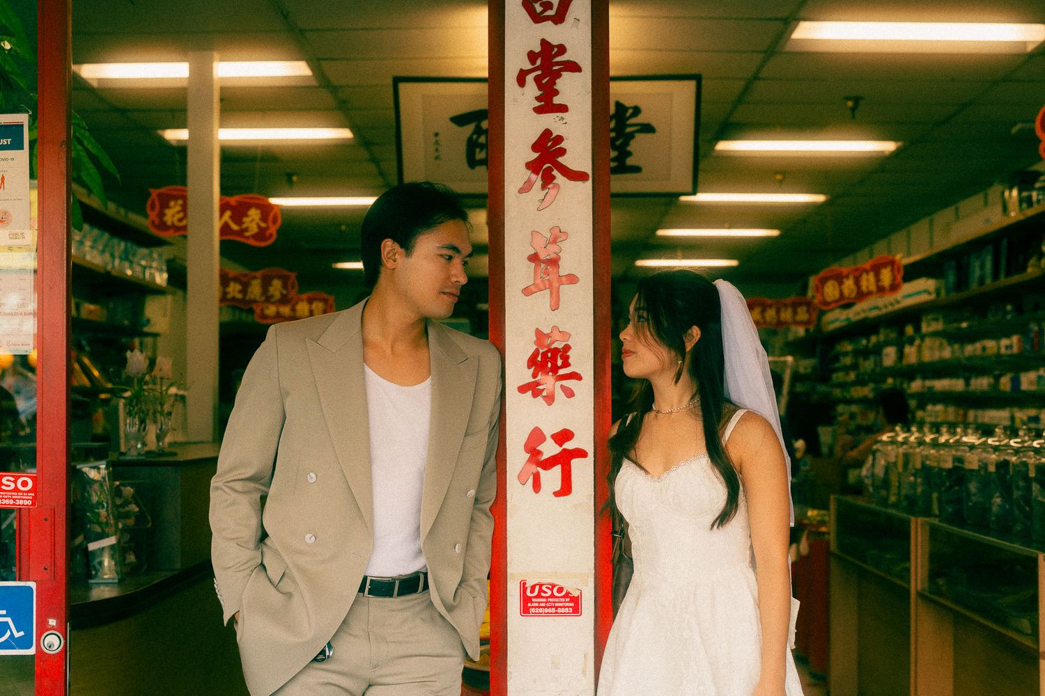 Taipei pre-wedding photography of a couple standing by a traditional Taiwanese storefront