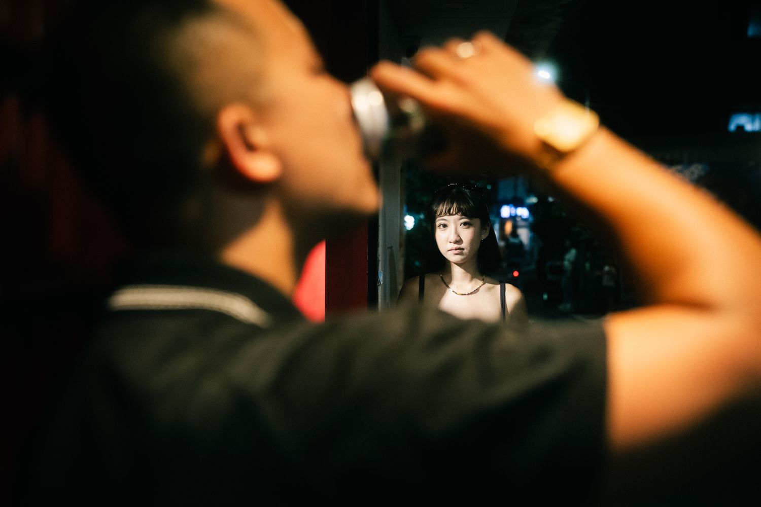Cinematic night portrait in a Ximending alley with Taiwan Beer during a Taipei couple photoshoot