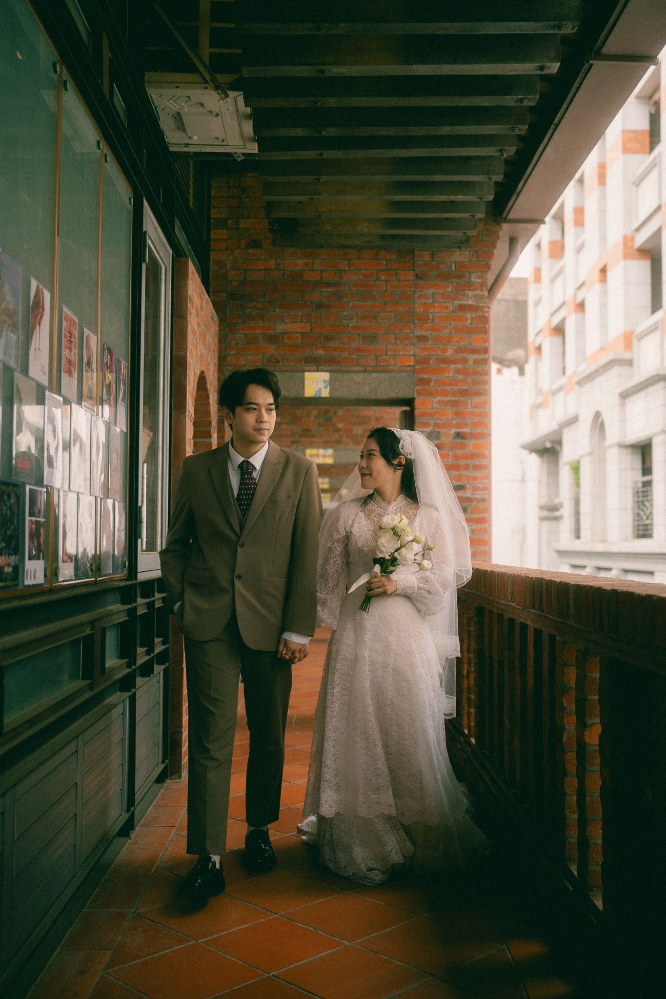 Cinematic Taipei pre-wedding portraits of a couple exploring the historic corridors and stairways of Dadaocheng