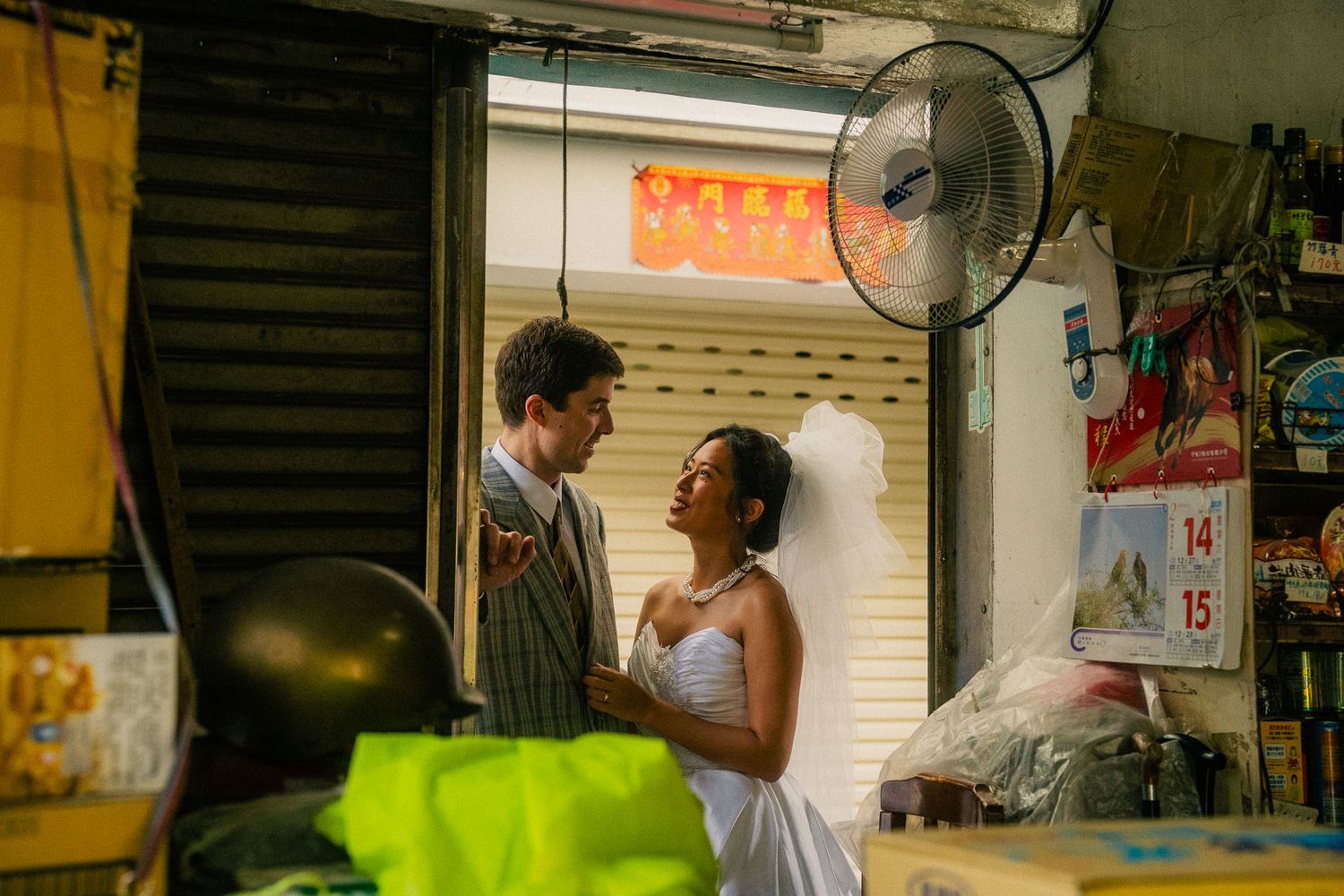 Emily and Nik laughing inside a traditional market shop during their Dihua Street couple session in Taipei