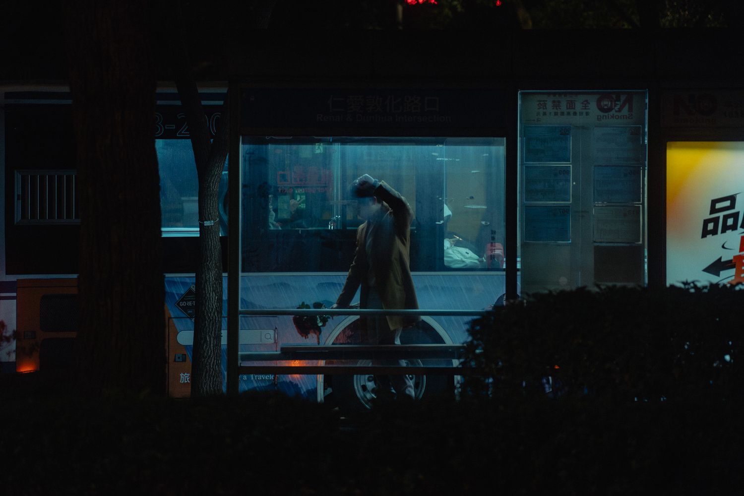 Cinematic Taipei lifestyle portrait of a content creator by a bus stop