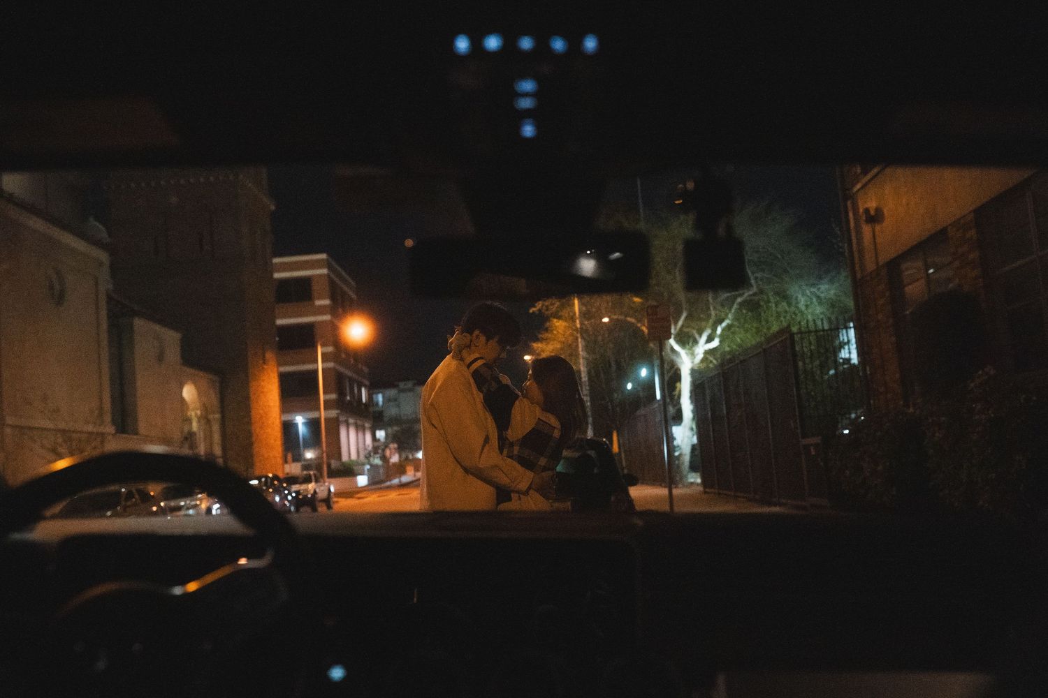 Cinematic Taipei couple photography of two people embracing on a quiet city street at night