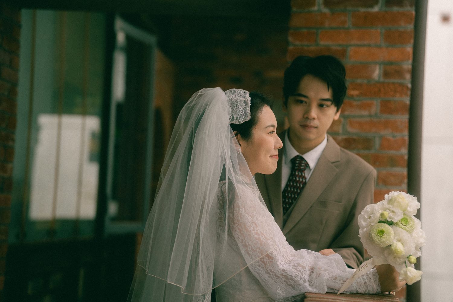 Cinematic Taipei pre-wedding portraits of a couple exploring the historic corridors and stairways of Dadaocheng