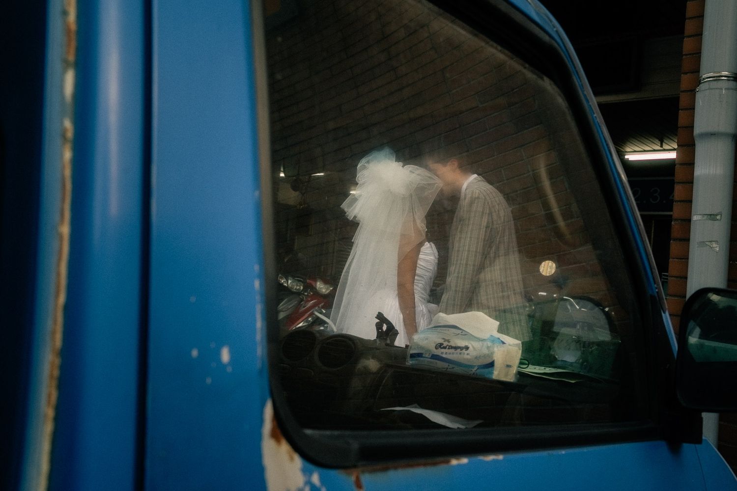 Emily and Nik photographed through a truck window during their Dadaocheng pre-wedding gallery